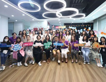 Group photo of OpenNOut China team holding up signs from campaign (photo)