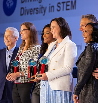 CEO Joaquin Duato and CDEIO Wanda Bryant Hope celebrate with the members of the STEM team (photo)
